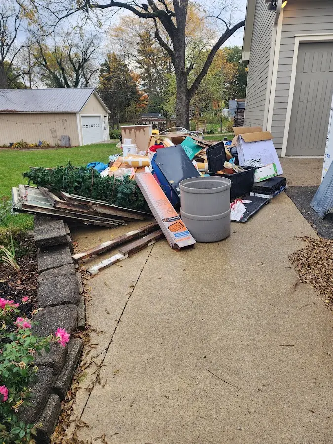 Dumpster being loaded with debris for 12 Yard Dumpster Rental in Piqua